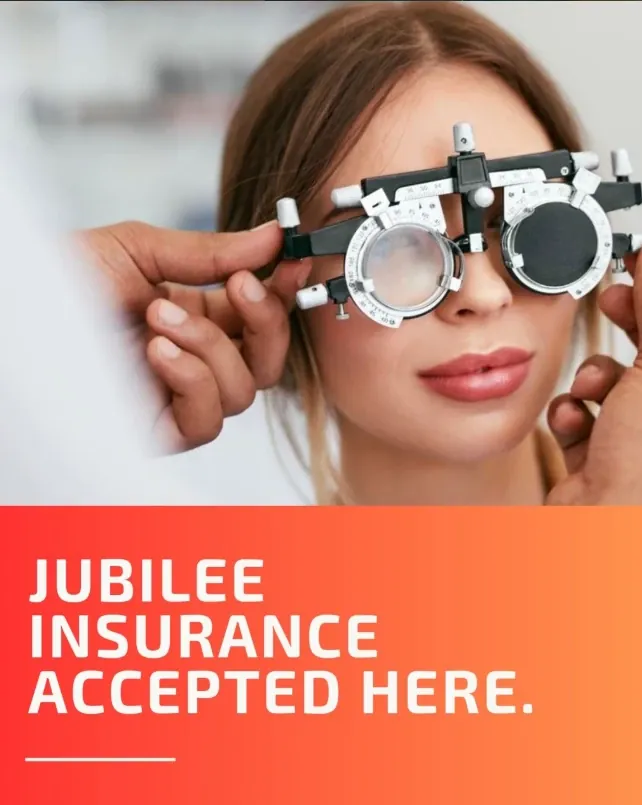 Optometrist fitting a trial frame during an eye examination — Jubilee Insurance accepted at Siha Optical & Eye Center